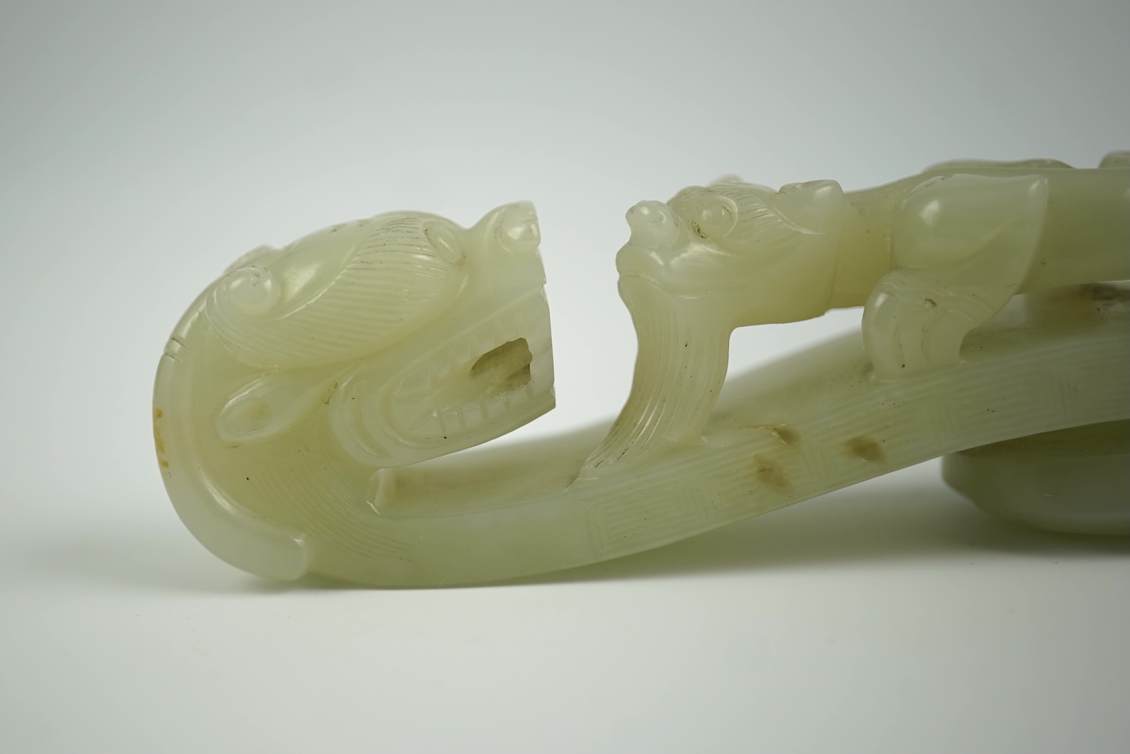 A Chinese pale celadon jade 'dragon' belt hook, 18th/19th century